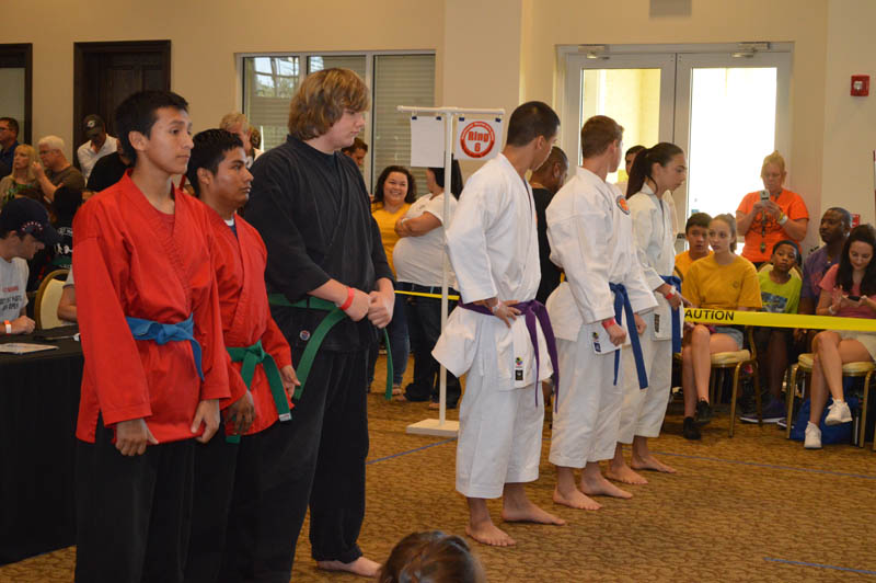 line of students in martial arts uniforms